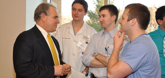 Jeffrey Keller, PhD, left chats with neurosurgical residents