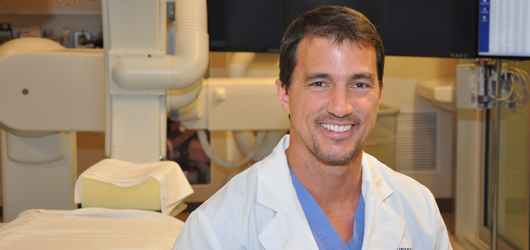 Andrew Ringer, MD, in the angiography suite at University Hospital. Photo by Cindy Starr / Mayfield Clinic.