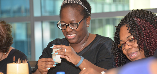 Wilona Portis, left, and Nakeisha Horton experiment with colors and materials.